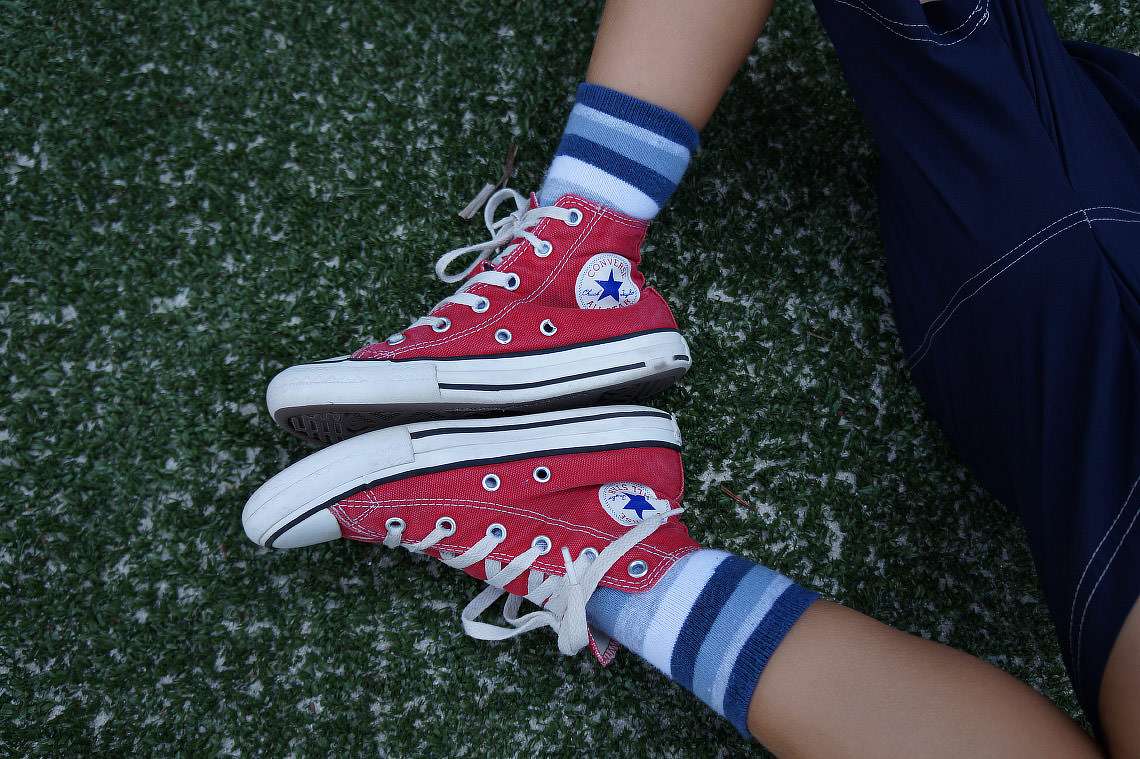 Girl wearing red on sale converse high tops